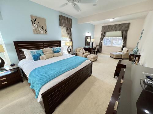 a bedroom with a large bed and a living room at Luxurious Getaway Pool Hot Tub Theater Gym Outdoor Kitchen BBQ 2 Miles to Disney in Orlando
