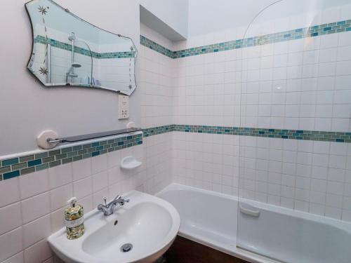 a bathroom with a sink and a toilet and a tub at No9 Budle Sands in Bamburgh