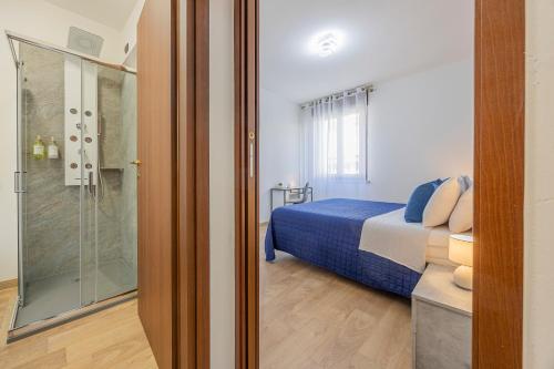 a bedroom with a bed and a glass shower at PRESTIGE Apartments - Blue Serenity in Verona