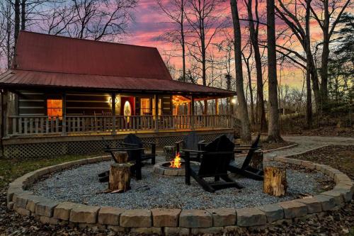 a fire pit in front of a log cabin at Smokies Log Cabin Hot Tub, Fire Pit & Arcade in Townsend