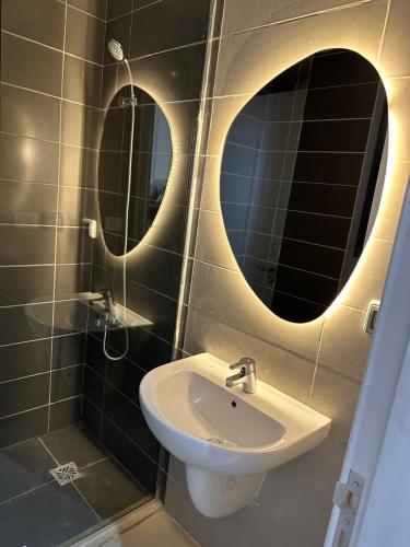 a bathroom with two mirrors and a sink at Penthouse El Gouna, Hurghada in El Gouna
