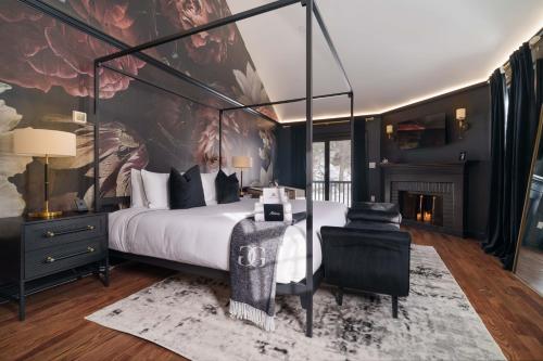 a bedroom with a canopy bed and a fireplace at Garden Gables in Lenox