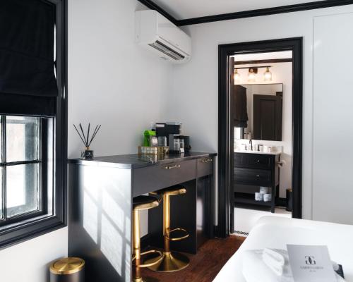 a room with a bar with a sink and a mirror at Garden Gables in Lenox