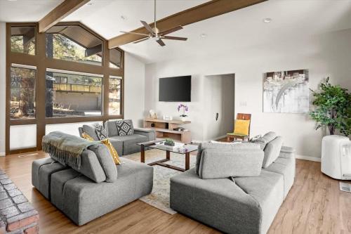 a living room with two couches and a tv at High Pines Lodge in Flagstaff