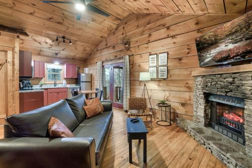 a living room with a couch and a fireplace at Dog friendly, Hot Tub & Near Tuckaleechee Caverns in Townsend