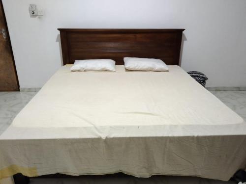 a large white bed with two pillows on it at Lankadays in Negombo