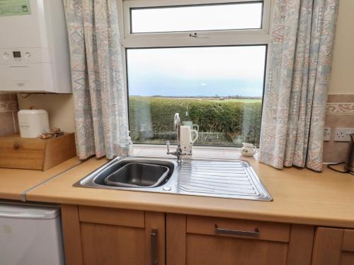 a kitchen with a sink and a window at The Retreat in Alnwick