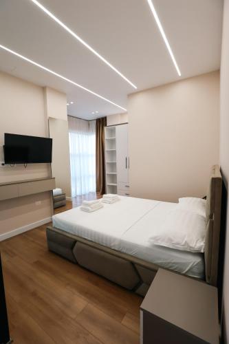 a bedroom with a bed and a flat screen tv at STAR Hotel in Bathore