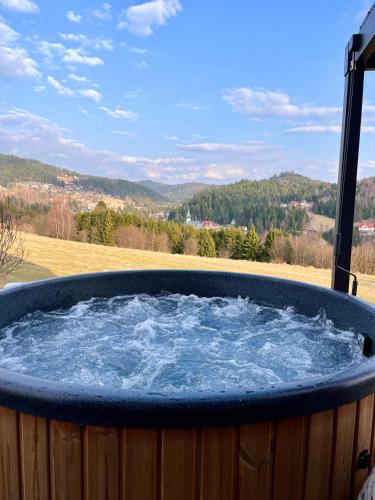 a large hot tub with blue water in it at Wichrowy Domek Nowy Targ - Podhale - Tatry - Gorce - Balia in Nowy Targ