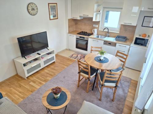 a kitchen and living room with a table and chairs at Apartment Silvia Zagreb- Free Private Parking, in Zagreb