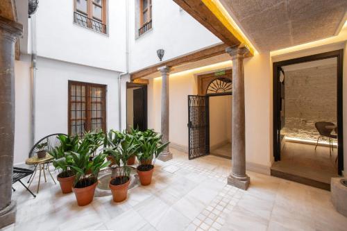 a room with potted plants in a building at Patio Nazarí Suites in Granada
