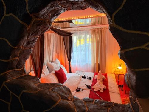a living room with a bed and a couch with stuffed animals at Apartmán Mair Pardubice in Pardubice