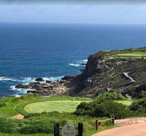 a golf course on a cliff with the ocean at Pinnacle Golf Estate Haven in Mossel Bay
