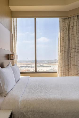 a bedroom with a bed and a large window at Residence Inn by Marriott Los Angeles LAX/Century Boulevard in Los Angeles