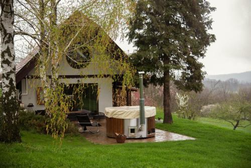 a house with a hot tub in the yard at KisHáz a Zselicben in Zselickisfalud