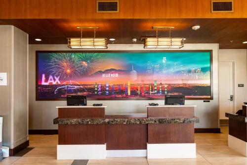 a large screen in a lobby with a large display at Residence Inn by Marriott Los Angeles LAX/Century Boulevard in Los Angeles