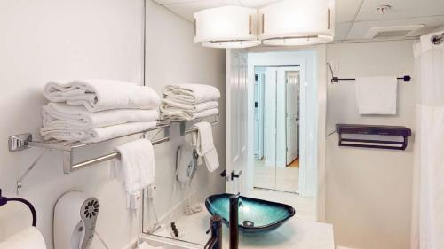 a bathroom with a sink and a mirror and towels at Cascade Lodge in Whistler