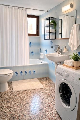 a bathroom with a washing machine and a washer at The Citrus Yard in Politika, 2 bedrooms apartment in Politika