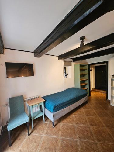a bedroom with a bed and a table and a chair at Ojcówek in Grzymek
