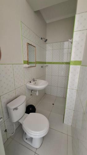 a bathroom with a toilet and a sink at Hospedaje Jasmine in Tarapoto