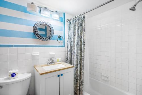a bathroom with a white toilet and a sink at Pool Front & Across from Beach in Myrtle Beach