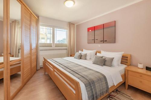 a bedroom with a large bed and a bathroom at Haus Strandoase 04 in Bansin