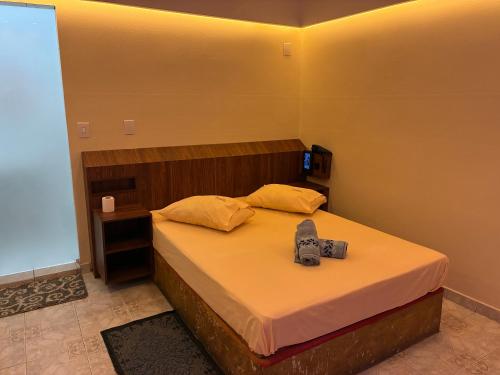 a bedroom with a bed with a camera on it at HOTEL SMART LOVE in Carapicuíba
