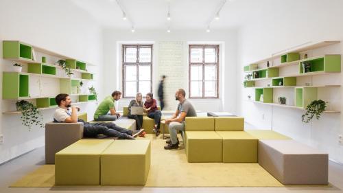 a group of people sitting in a room with boxes at Flow Spaces in Budapest