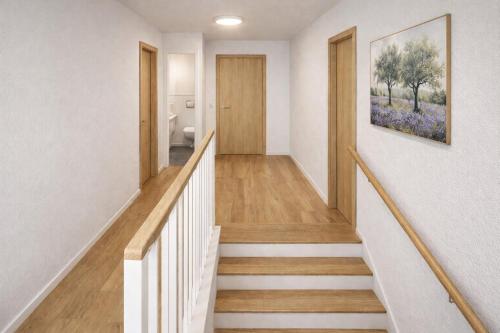a staircase in a house with a painting on the wall at Chalet Villa Pia in Bichlbach
