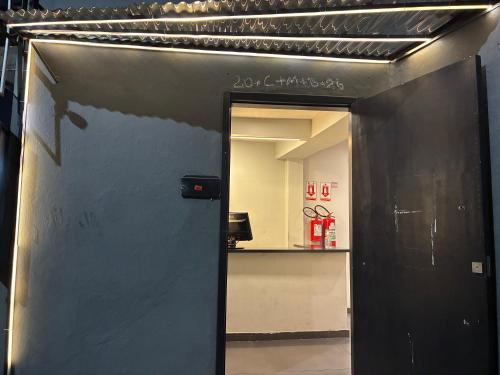a black door leading into a room with a counter at HOTEL SMART LOVE in Carapicuíba