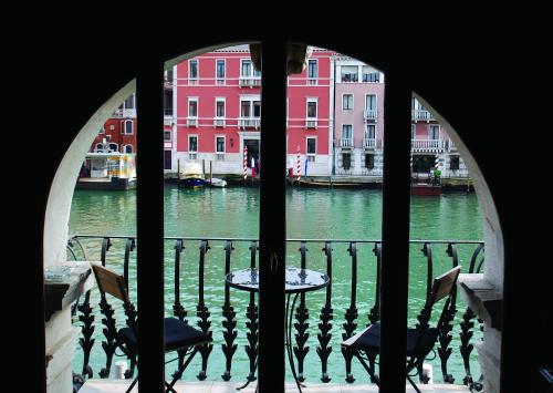 a view of a canal from a window at Hotel Palazzo Barbarigo Sul Canal Grande in Venice