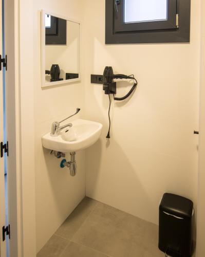 a bathroom with a sink and a mirror at Hostel Nixar in Almería