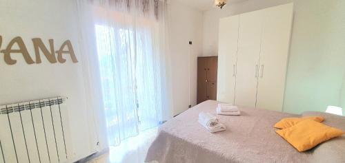 a bedroom with a bed with towels on it at Dei Della Costiera in Agerola