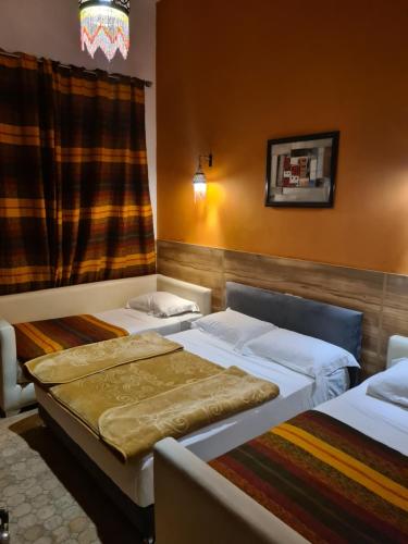 Un pat sau paturi într-o cameră la Riad Passiflora