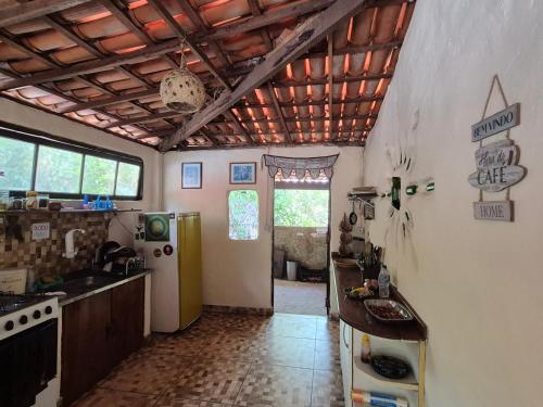 a kitchen with a refrigerator and a counter in it at Bela Oyá Casa Hostel in Vale do Capao