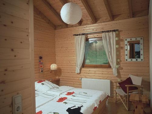 a bedroom with a bed in a wooden room at Feriendorf Reinskopf in der Eifel in Schönecken