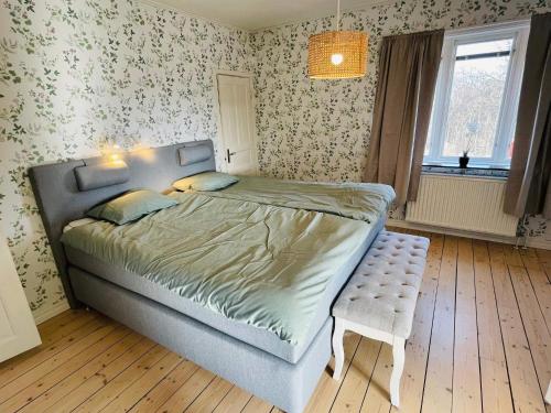 a bedroom with a bed and a bench in it at 8 person holiday home in Moheda-By Traum in Moheda