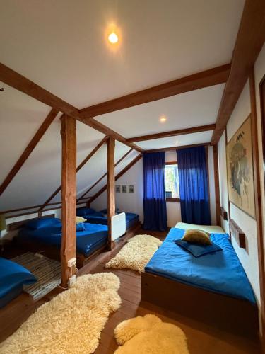 two beds in a room with blue sheets at Forest Lodge & Spa in Gauja National Park - Kaķukalns in Straupe