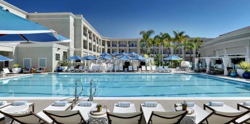 a pool at a hotel with chairs and umbrellas at Balboa Bay Resort in Newport Beach