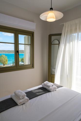 a bedroom with a bed with two towels on it at Villa Selina 1 - Etheras Properties in Kythira