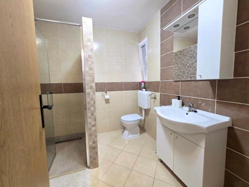 a bathroom with a toilet and a sink at Apartman Jadranka in Vir