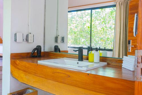 a bathroom with a sink and a large window at Mayan Monkey Isla Mujeres - Social Hotel in Isla Mujeres