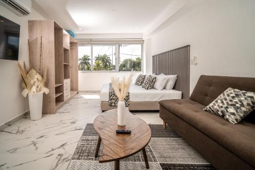 a living room with a couch and a table at Barcelona Condos Cancun in Cancún