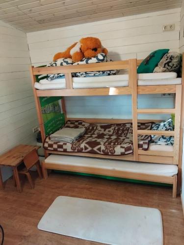 a room with three bunk beds with a teddy bear at Maamaja puhkuseks in Kibuna