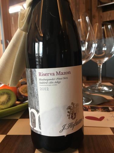 a bottle of red wine sitting on a table at Hotel Vela Azzurra in Malcesine