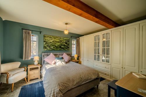 a bedroom with a bed and a chair at Cantre Selyf in Brecon