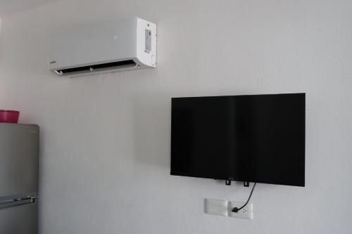a flat screen tv hanging on a wall at CASA JARDIN in Cancún