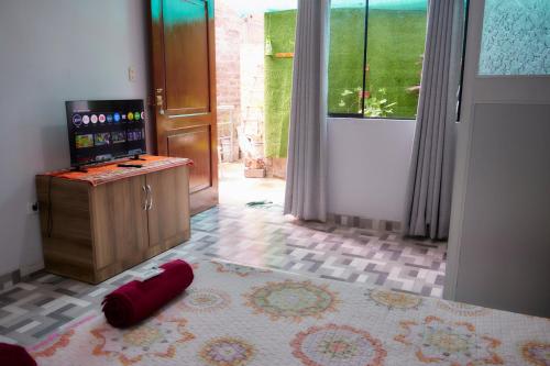 a room with a door and a red object on the floor at TuKasa Boutique Liberdad - Buen cafe en Terraza Interior in Ayacucho