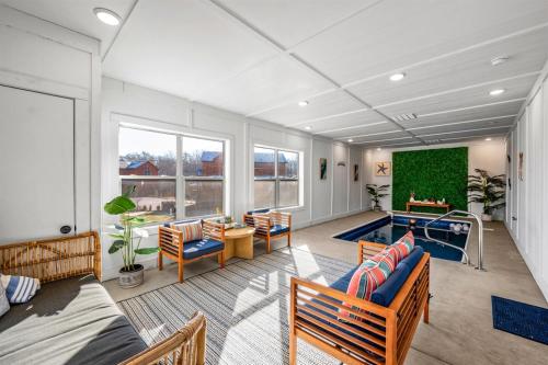 a large living room with a pool in it at Indoor Pvt Pool, Pkyway, 44, HotTub, BBQ, King in Pigeon Forge