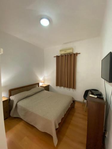 a bedroom with a bed and a television at Casa Uruguay in Piriápolis